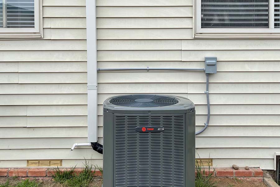 AC condenser unit outside home for cooling system repair